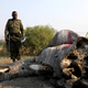Botswana Defence Force (BDF) officers inspect the carcass of an elephant in the Linyanti area, Botswana,